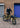 Person standing next to a yellow Unicorn Cargo Bike against a brick wall.